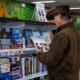 Image of Man browsing jigsaw puzzles and large print books